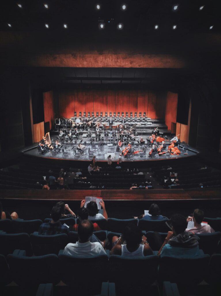 pexels-photo-2372945-2372945 Capture of a live orchestra setup in an indoor concert hall with audience seated.